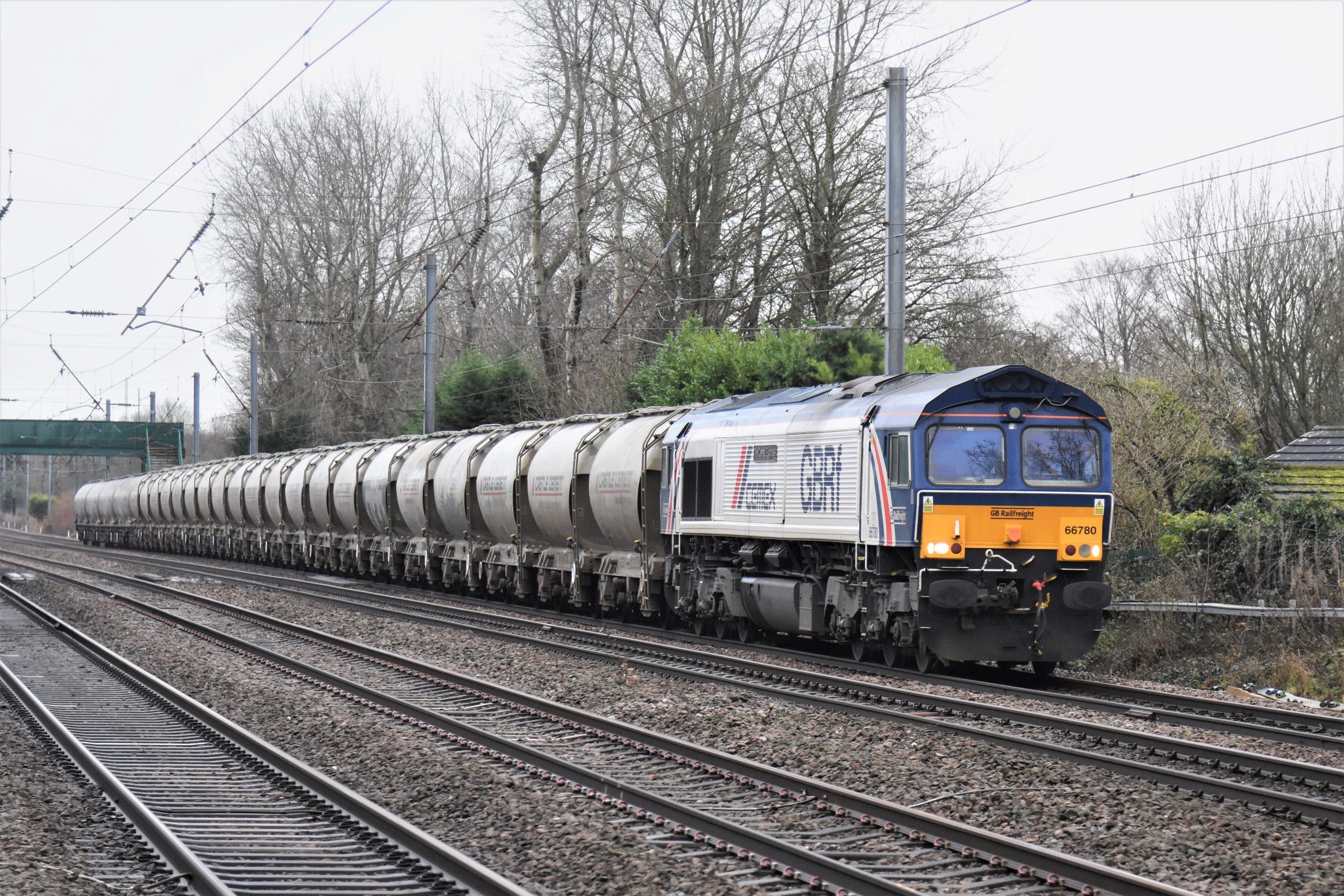 Cemex liveried 66780 "The Cemex Express" is seen near Balshaw Lane and Euxton on 11th December 2021 · Image credit: John Sloane