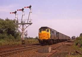 31432 at Ely North Junction with 5L87 Leeds Cambridge vans on 22-07-1989