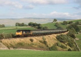 On a beautifully sunny 27th August 1988, Class 47 No. 47517 'Andrew Carnegie' has left Kirkby Stephen and is about to cross Smardale Viaduct as it heads North with the ten coach 16.33 Leeds to Carlisle. Photo: Stewart Jolly.