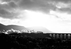 60800 'Green Arrow' is silhouetted by the low sun as it runs onto Ribblehead Viaduct with the Northbound 'Cumbrian Mountain Express' on 28th December 2001. Photo: Michael Smyth.