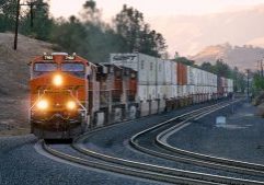 Taken in the early evening of 12th October 2015, BNSF Railway ES44C4 #7162 leads a quartet of hard-working General Electric diesels on a double-stack intermodal climbing through Woodford passing siding on the Tehachapi Pass, California. Photo: Tony Field
