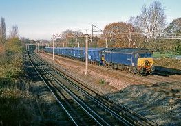 57310 hauls 768001 and 319373 as the 05.34 Shieldmuir to Willesden PRDC parcels service at Headstone Lane on 23rd November 2021. Image Crdedit: Geoff Brockett.