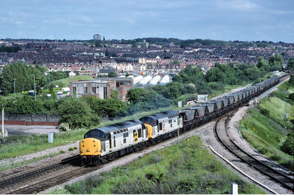 37796 & 37702 make an impressive sight (and sound!) as they head up Filton bank with 6B12, the 14.35 SO returning coal empties from Westbury Cement Works to Barry on 1st June 1996. Image credit: Stewart Jolly
