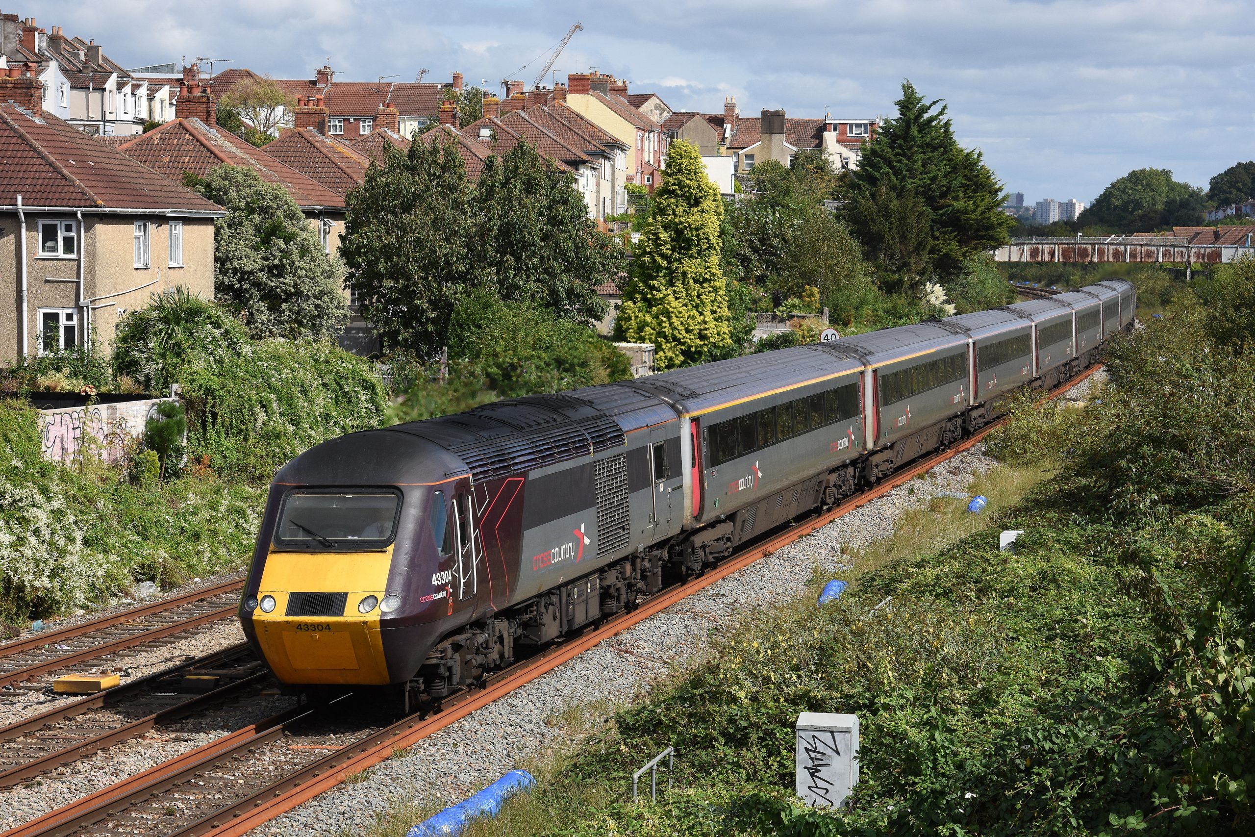 On 13th September 2023, a few days before Cross Country withdrew its HST fleet from regular service, 43304 and 43303 are pictured approaching Parson Street station with 1V50, the 06.06 Edinburgh to Plymouth.  The overgrown land to the right of the picture was formerly Malago Vale carriage sidings.  Image credit: Stewart Jolly