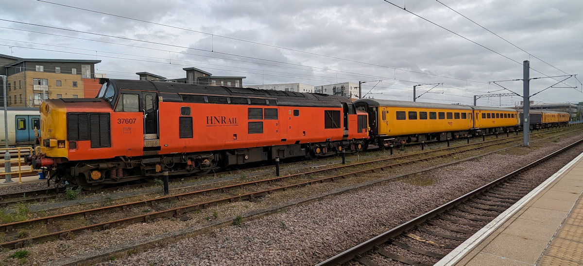 HN Rail Class 37 No. 37607 (formerly 37511/37103) is seen at Cambridge on April 5th 2024 after arrival forty minutes early at 04.30 with 3Q55 04.12 from Welwyn Garden City. This is an Ultrasonic Test Train with vehicle 62384, second from the rear, as the test unit. 62384 was formerly the MBSO in 4-CIG unit No. 7396 (later 1393). It entered preservation on the Great Central but was sold to Network Rail in September 2011, re-entering service as Ultrasonic Test Unit 1 (UTU-1) in May 2012. Photo: Tony Field.