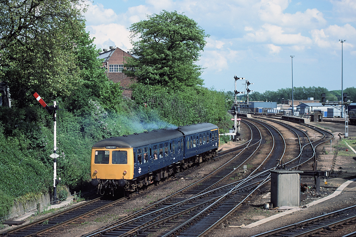 Cravens cars E54433 and E51265 accelerate past Norwich Thorpe Junction with the 14.35 to Lowestoft on 2nd June 1984. The highly polished single slip and loop lines indicate the level of activity between the depot and the station, with many empty stock movements throughout the day. Photo: Stewart Jolly. 