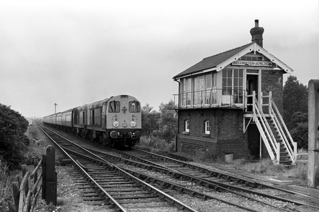 19840804-BELLWATER-Jc-2004120113-08-16-SO-Leicester-Skegness-4-Alan-Jones-E3W The classic Bellwater Junction view showing Class 20s Nos. 20041 and 20113 on the 08.16 (Summer Saturdays) Leicester to Skegness on August 4th 1984. The box was opened in 1913 when the 'New Line' to Coningsby Junction opened and was the Great Northern's final design of signal box. The bargeboards show a little craftsmanship, and although the nameboard at the far end is in the traditional cast letter style of the Great Northern, the board at this end is painted (and subject to advanced decay). Photo: Alan Jones.
