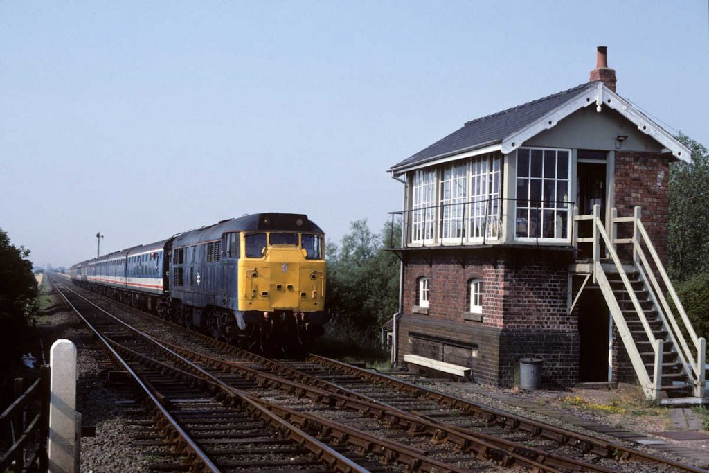 19900804-BELLWATER-Jc-31257-06-30-SO-Sheffield-Skegness-2-Alan-Jones-EW2 Bellwater Junction Signal Box was refurbished in the late 1980s and although it lost its nameboard above the entrance, the majority of the Box remained in tact. The impact of sectorisation is beginning to be seen as Network South East-liveried stock now forms part of the 06.30 Sheffield to Skegness behind 31257 on August 4th 1990. Photo: Alan Jones.
