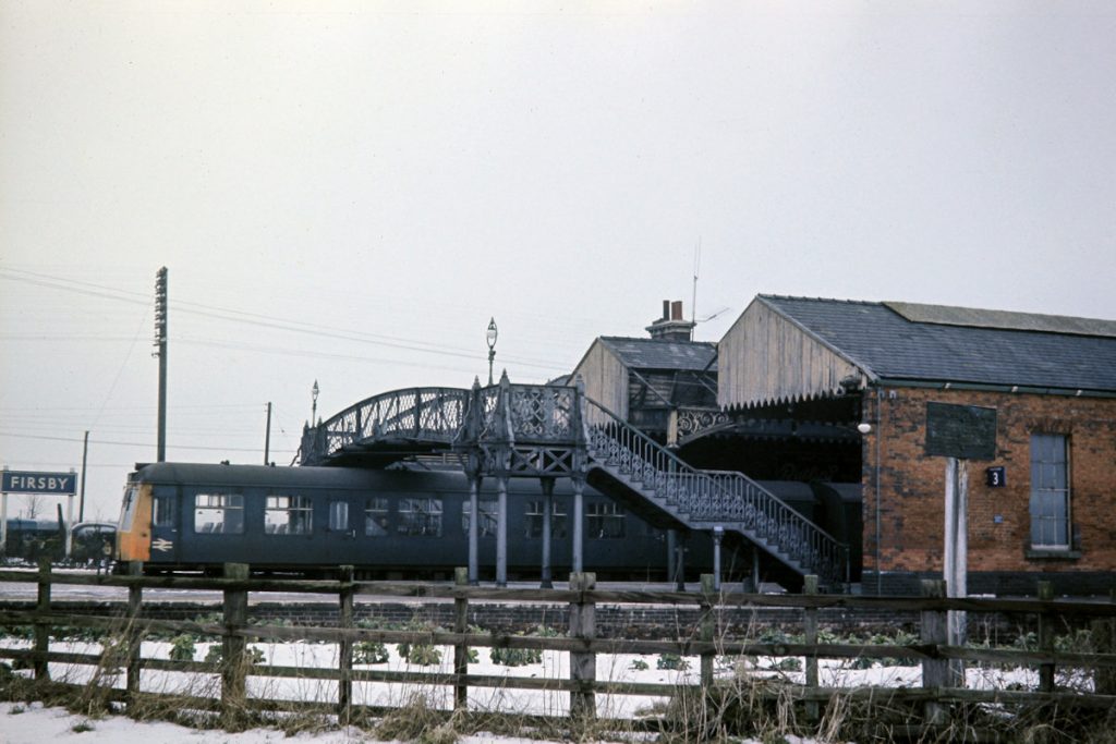 19700219-FIRSBY-Class-114-on-15 On February 19th 1970, the Skegness Branch train waits patiently at Firsby for custom before departing at 15.02. The lavishness of the infrastructure is well illustrated with the footbridge which contrasts today's minimalist functional approach. The curve round to the Skegness Branch was single line, and track-circuited. It could be accessed from either Platform 1 (Down Main) or Platform 3 which was a loop off the Up Main (the Platform 3 sign is visible on the wall of the station building) but there was no direct access from the Up Main (Platform 2). Photo: John Tolson, courtesy Trevor Davis.