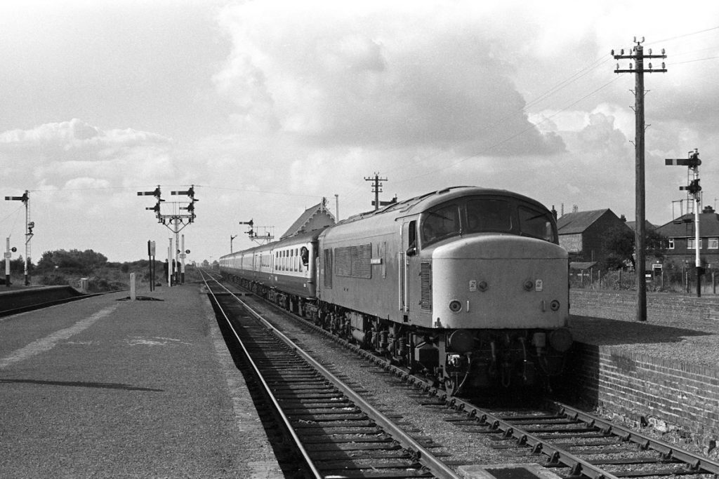 19830917-SKEGNESS-45123-1E85-09-22-SO-from-Derby-2-Alan-Jones-E4W Class 45/1 No. 45123 'The Lancashire Fusilier' looks smart as it arrives into Skegness station on September 17th 1983 with the 09.22 from Derby. Apart from the leading vehicle, the stock is air conditioned Mark 2, recently displaced from the Midland Main Line by the arrival of High Speed Trains. It did not last long on such lowly duties, being redeployed onto other Inter-City services later in the year. Photo: Alan Jones.