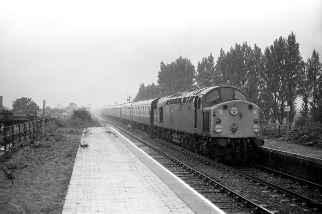 19840804-WAINFLEET-40044-08-15-SO-Manchester-Skegness-90-late-due-to-failed-31248-on-Leeds-Skegness-Alan-Jones-E4W Not the most auspicious start to a week's holiday in Skegness - in a downpour of monsoon proportion, 40044 is running 90 minutes late with the 08.15 (SO) Manchester to Skegness as it slows for the tight curve at Wainfleet on August 4th 1984. The leading end of the locomotive, without doors, was rebuilt following the locomotive's accident at Chinley in 1978. Photo: Alan Jones.