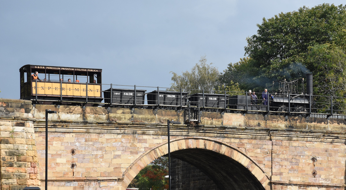 20250927-DARLINGTON-NORTH-ROAD-Skerne-Bridge-LOCOMOTION-5Z02-12 On Saturday 27th September 2025, the replica 'Locomotion' re-enacted a small part of the original journey from Shildon to Stockton of exactly 200 years earlier, which led to the railways we have today. Running on the National network as 5Z02, 12.00 Hopetown to Hopetown, Locomotion crosses Skerne Bridge, on the original Stockton and Darlington Railway, to the delight of several thousand onlookers below. Photo: Alan Jones.