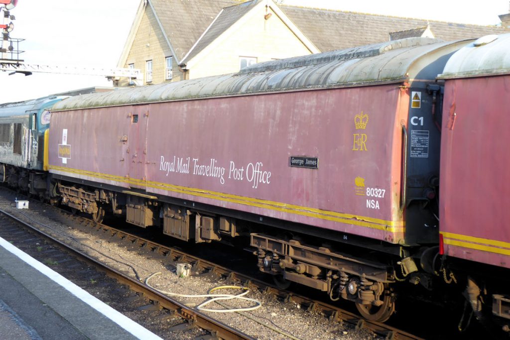 20240928-WANSFORD-80327-George-James-19 Looking a little tired after twenty years out of service, NSA vehicle 80327 'George James' (built York, 1969) waits at Wansford station on September 28th 2024 with the Nene Valley Railway's 'Night Mail' Special. The bulge in the near-end of the roof is to accommodate the aerials of a VHF radio - one of a number of security features added to Post Office vehicles after the 1963 Great Train Robbery. The evening sun picks out the details of the B5 bogie. Photo: Alan Jones.