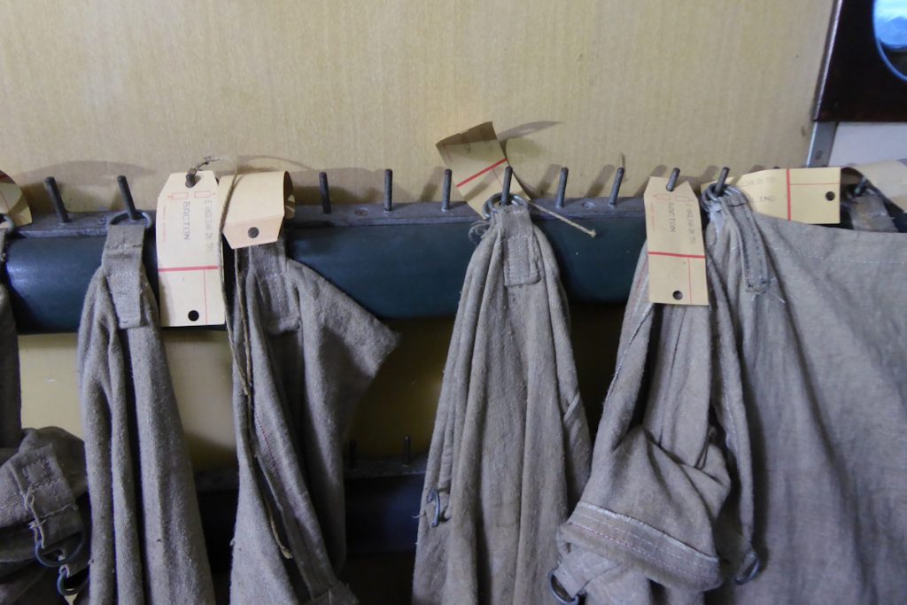 20240928-WANSFORD-80327-George-James-19 Labelled bags hang from the Bag Rail in NSA vehicle 80327 on the Nene Valley Railway's 'Night Mail' special on Saturday 28th September 2024. Runners in the sorting carriages would take letters from the sorting racks, bundle them up and drop them in to the appropriate bags as sorting progressed throughout the journey, thereby allowing sorting staff to concentrate fully on the business of sorting without distraction. Time was absolutely critical on all TPO workings and they were highly efficient operations where everyone knew their part. Photo: Alan Jones.