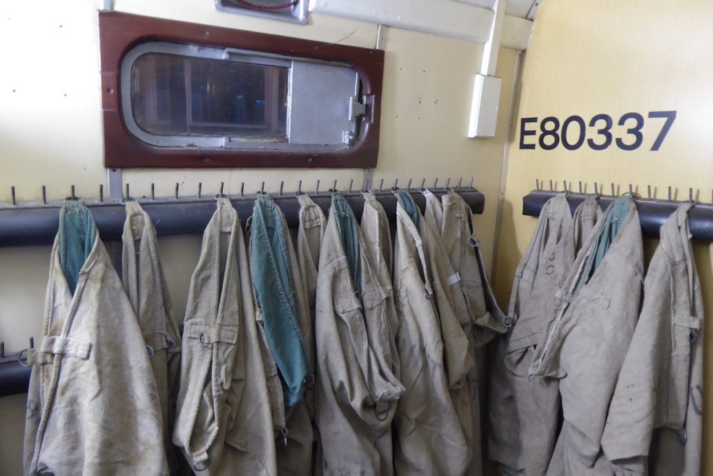 20240928-WANSFORD-80337-Brian-White-19 Bag Rails and bags in the corner by the wardrobe at the 'B' end of E80337, 28th September 2024. The window is of the smaller design, introduced as a security measure after the Great Train Robbery of 1963. Diagram 728/729/731/726 vehicles from E80319 onwards were fitted with these windows from new and Diagram 720/721 vehicles (80300-80318) had them retro-fitted and/or window bars fitted. Photo: Alan Jones.