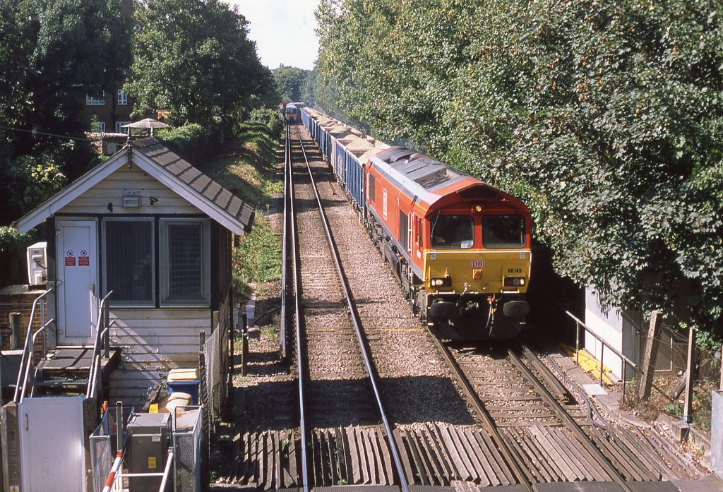 On 2 Sep 2020, 66149 passes Charlton Lane gate box with the 11.07 Angerstein Wharf to Woking conveying sea-dredged sand. Photo: Geoff Brockett.