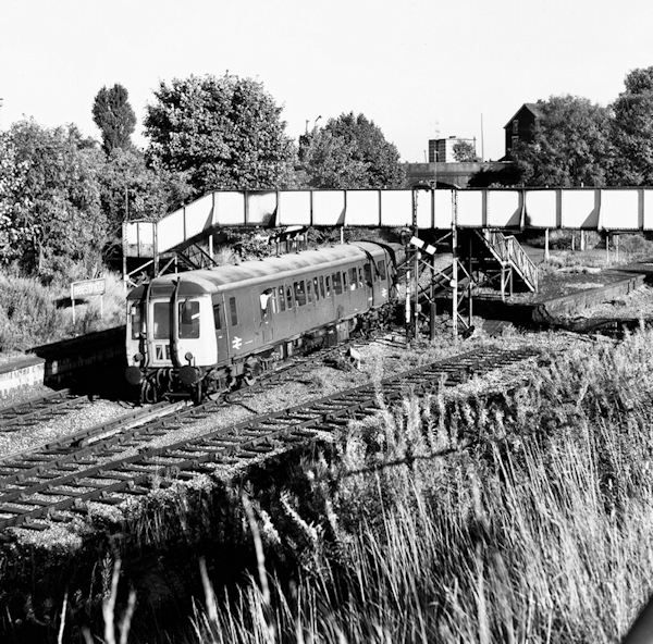 On August 31st 1971, Class 122 Gloucester RCW single car  unit W55012 departs from Priestfield with a Birmingham Snow Hill to Wolverhampton Low Level service. In the foreground the abandoned tracks of the Oxford, Worcester and Wolverhampton line towards Dudley can be seen. Photo: Michael Smyth.