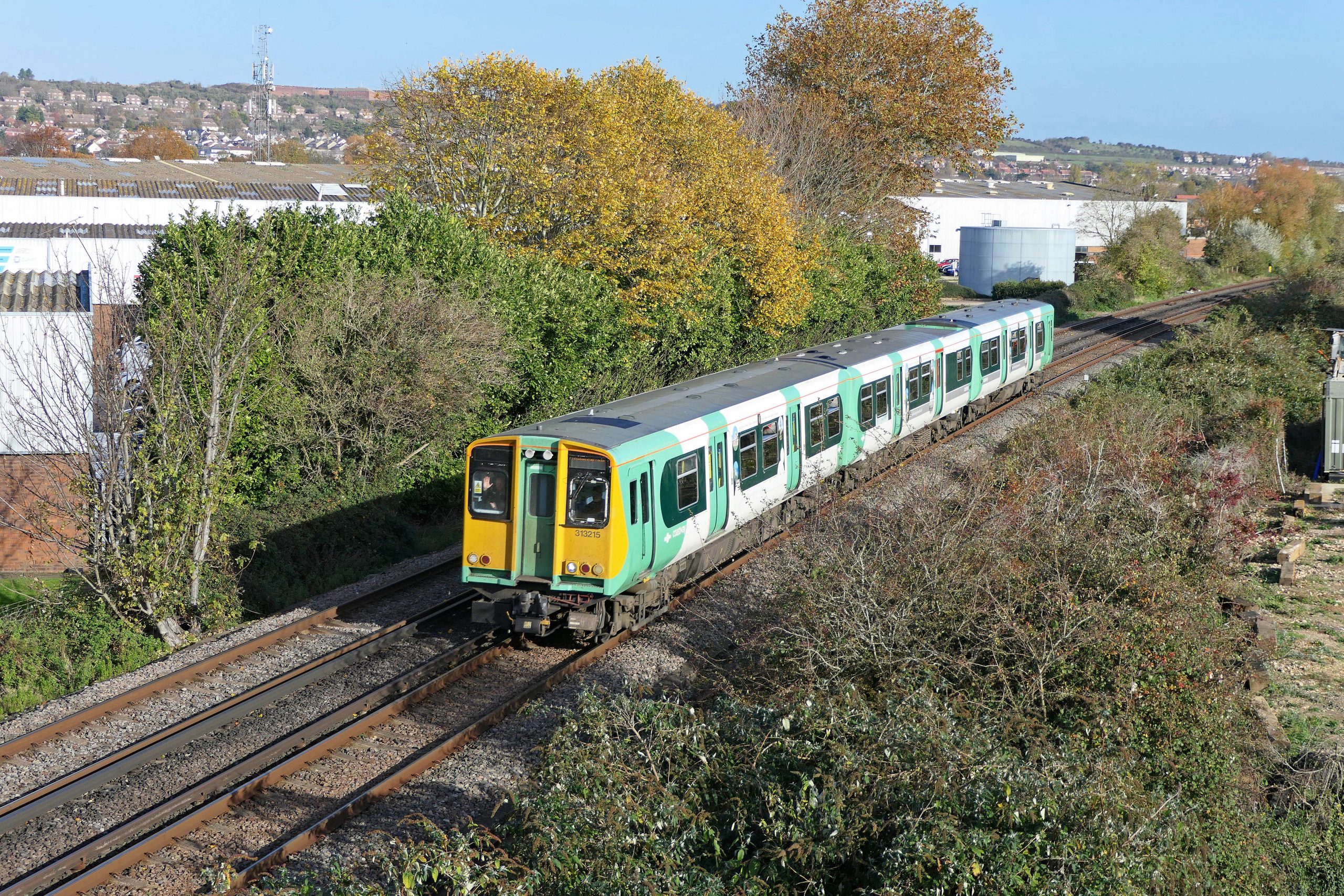 313 215 working a Brighton to Portsmouth service approaching Portcreek Junction. 17 November 2021.