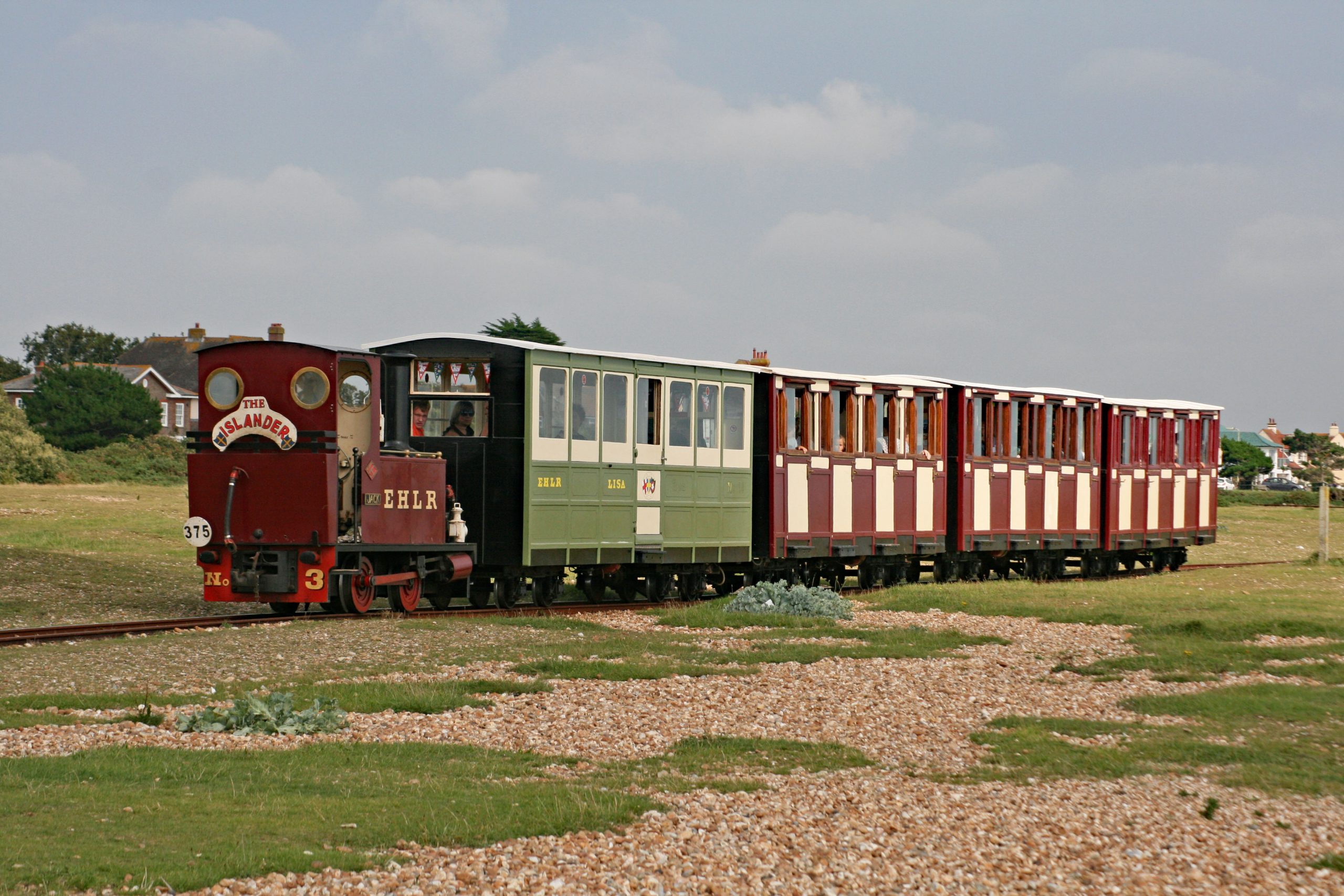 A Hayling Light Railway service wends it's way from Eastoke to Beachlands on a warm sunny summer day.   22 August 2017.  