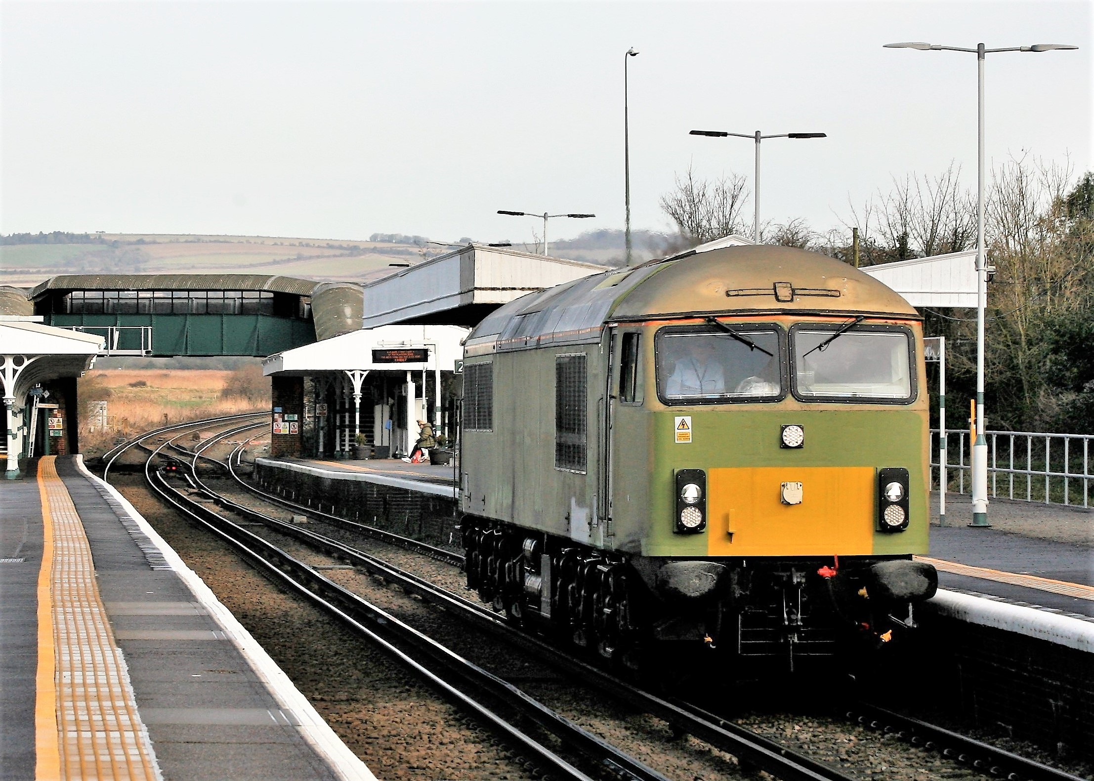 Class 69 69004 passes  Arundel Station at 11.40 Friday 29 January 2022 with 0Y69, the 09.59 Tonbridge West Yard to Eastleigh, for an appointment with the painters: the new livery is apparently going to be 'something special' for this loco.  Image Credit:  Julian Clark