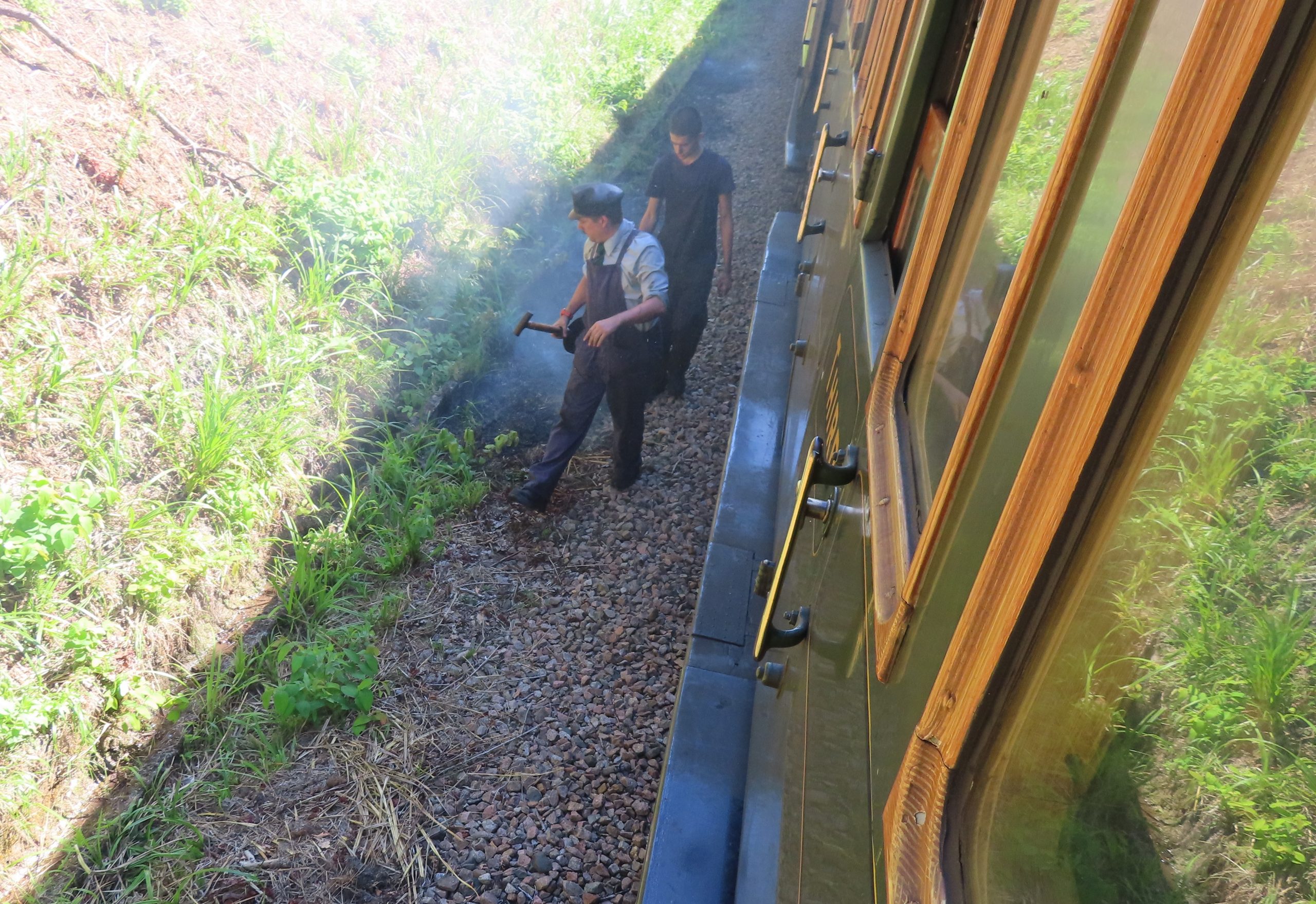 The crew finish putting out a lineside fire after bringing the train to a sudden stop just north of Horsted Keynes : Image Credit - Peter Young.