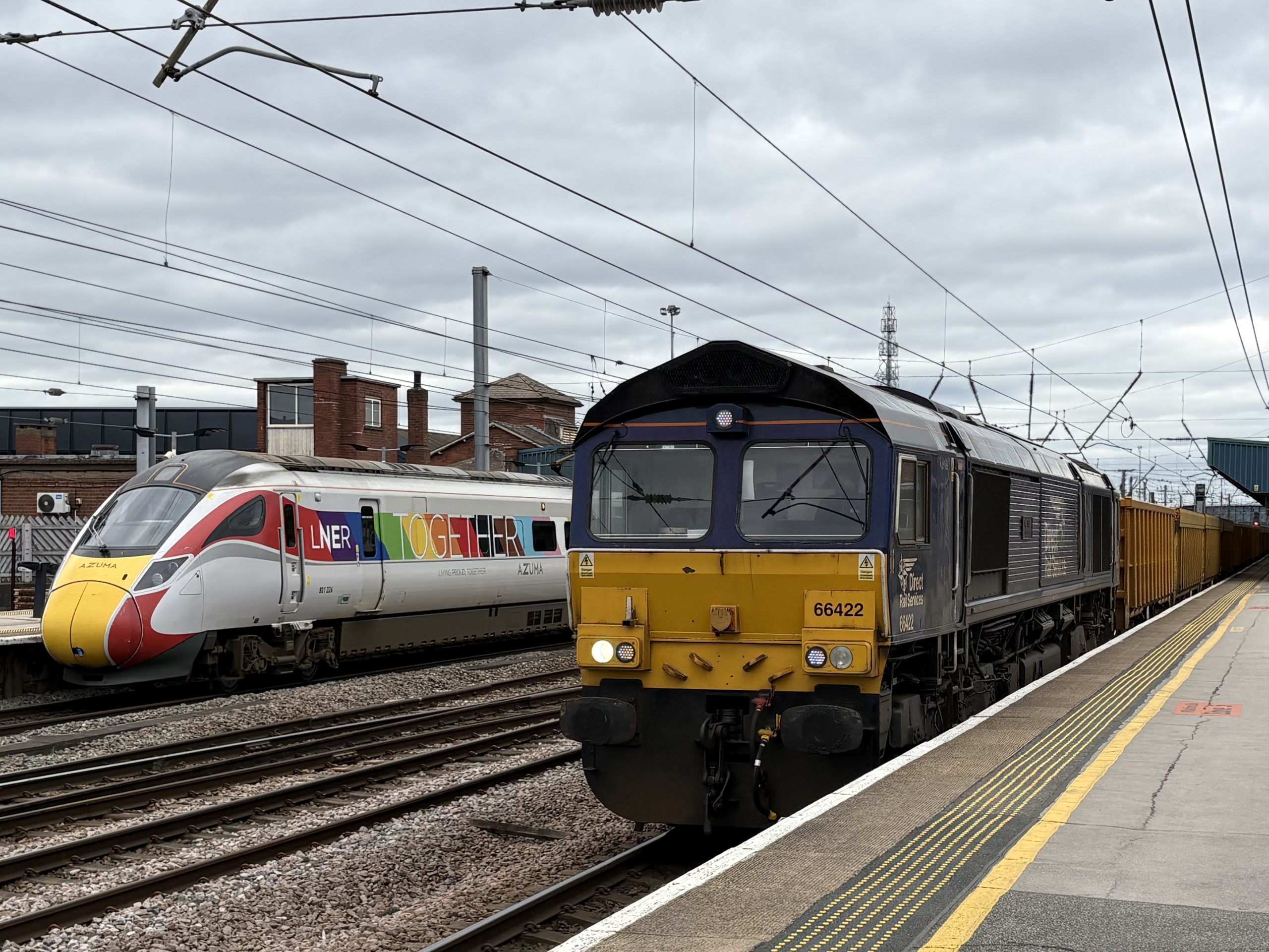 66422 passes platform 3A with the 6E73 service from Shap Summit Quarry to Doncaster Up Decoy while over on platform 4 stands the 12:10 service (1D14) from Kings Cross to Leeds : Image credit - Peter Hughes