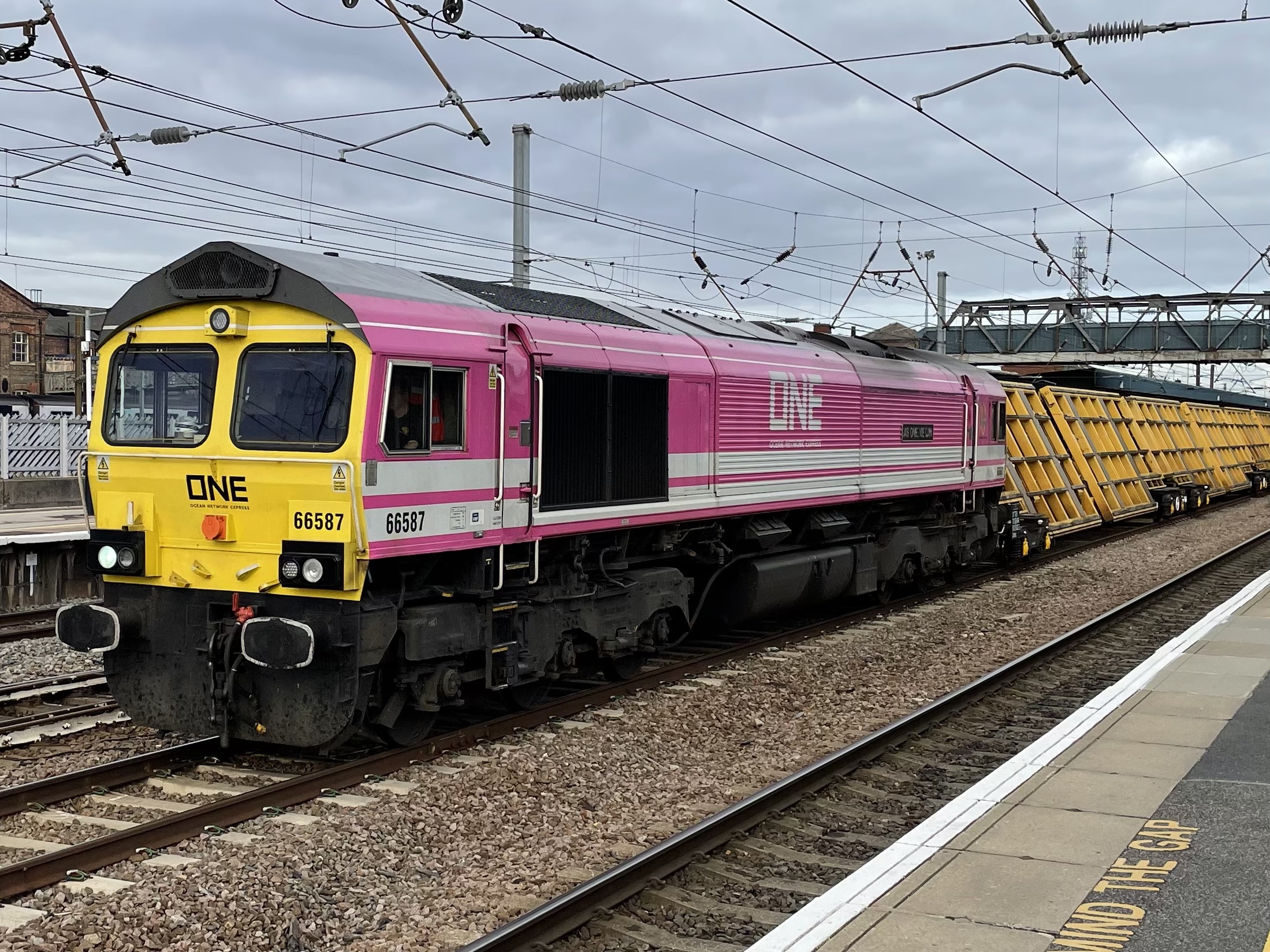 Freightliner 66587 "As One We Can" in its new striking Ocean Network Exp magenta livery following Freightliner’s partnership with ONE : Image Credit - Peter Hughes