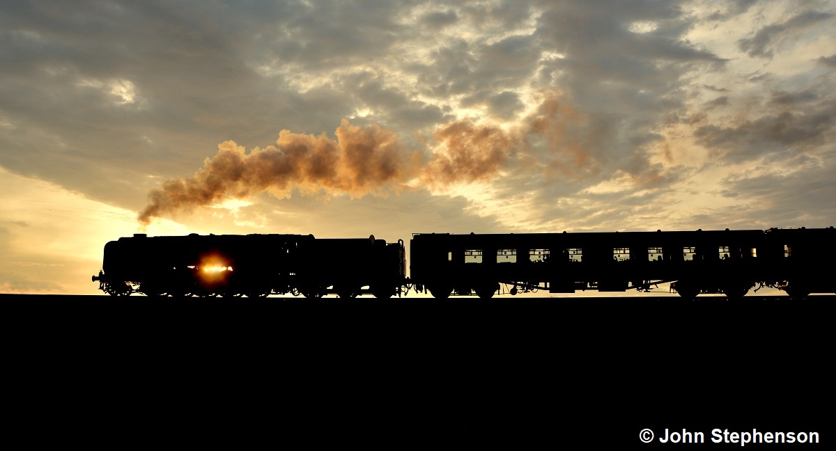 ''Decapod Sunset''  BR 9F 92203 is silhouetted as the sun sets at the North Norfolk Railway on 8th July 2023. John Stevenson